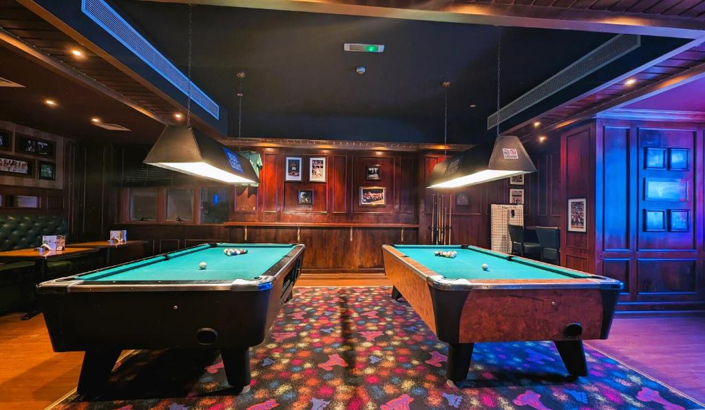 a billiard room with two pool tables in it at City Tower Hotel in Fujairah