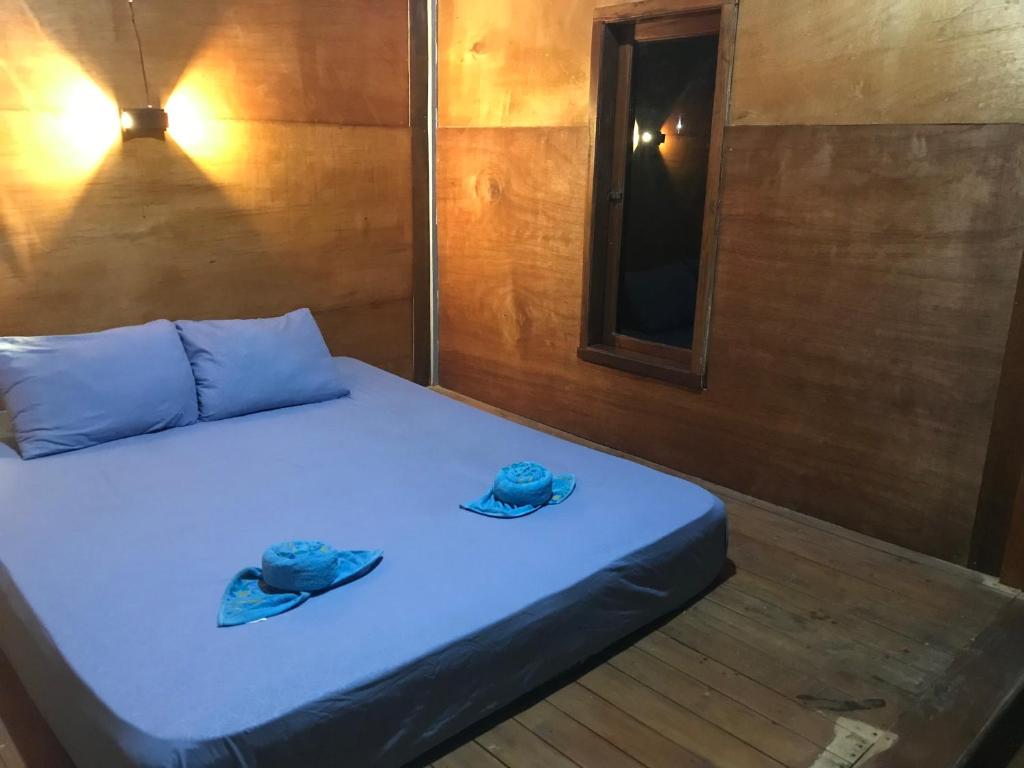 Postel nebo postele na pokoji v ubytování Muni's Lombok Bungalow