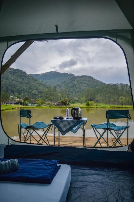 a view from the back of a boat with a table and chairs at Recanto do Vale Glamping in Pomerode