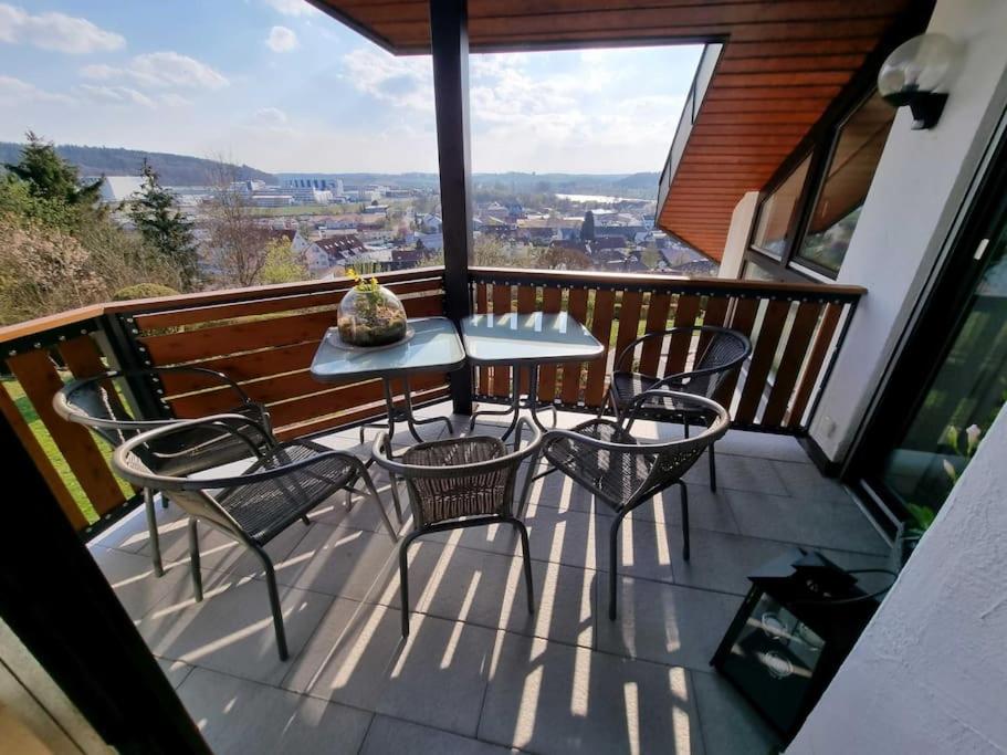 a balcony with three chairs and a table on it at Ferienwohnung Seeblick in Pfullendorf