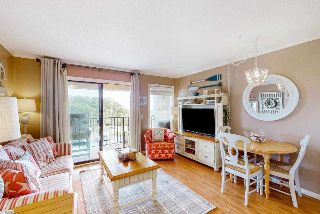 a living room with a couch and a table at HH Beach & Tennis 322B in Hilton Head Island
