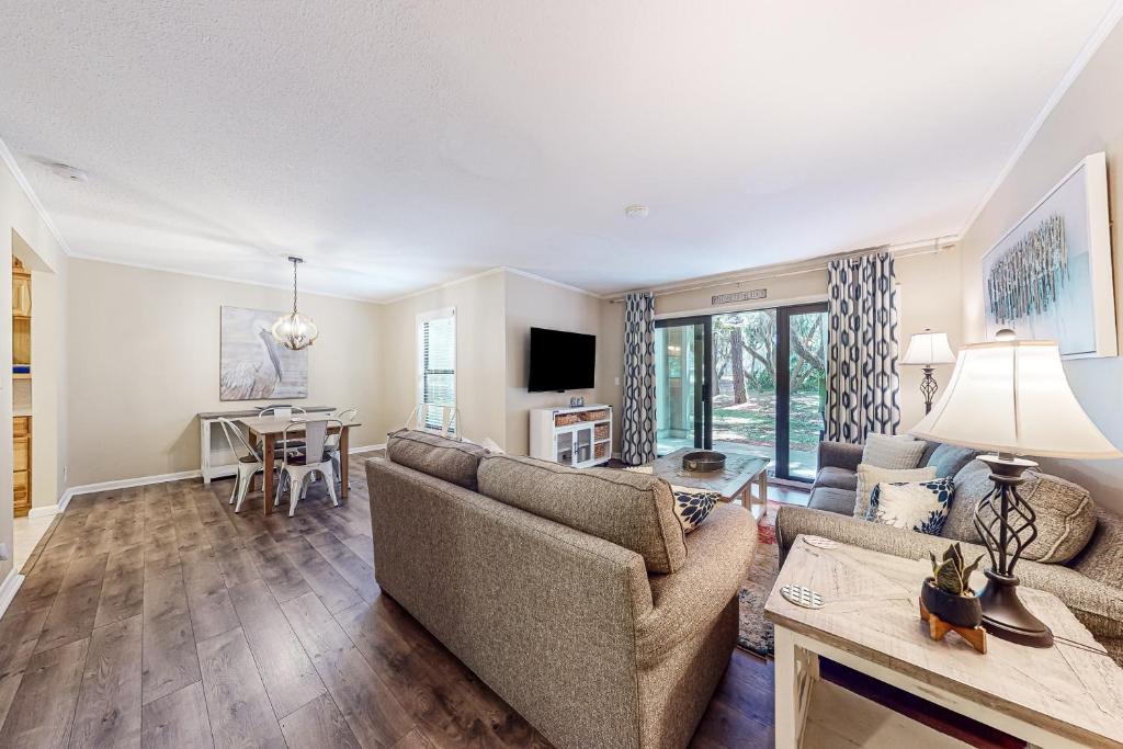 a living room with a couch and a table at High Hammock 171 in Seabrook Island