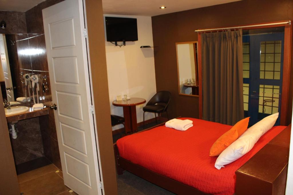 Postel nebo postele na pokoji v ubytování HOTEL AMTALLPA San Blas Inn