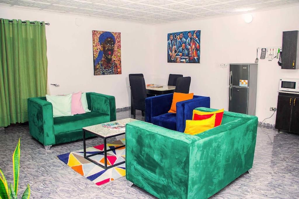 a living room with two chairs and a table at ARO (1.0) 2BD Studio Flat (Abule-Egba/Lagos) in Agege