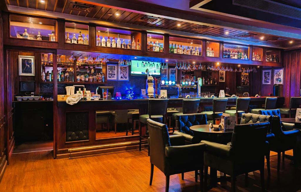 a bar with tables and chairs in a restaurant at City Tower Hotel in Fujairah