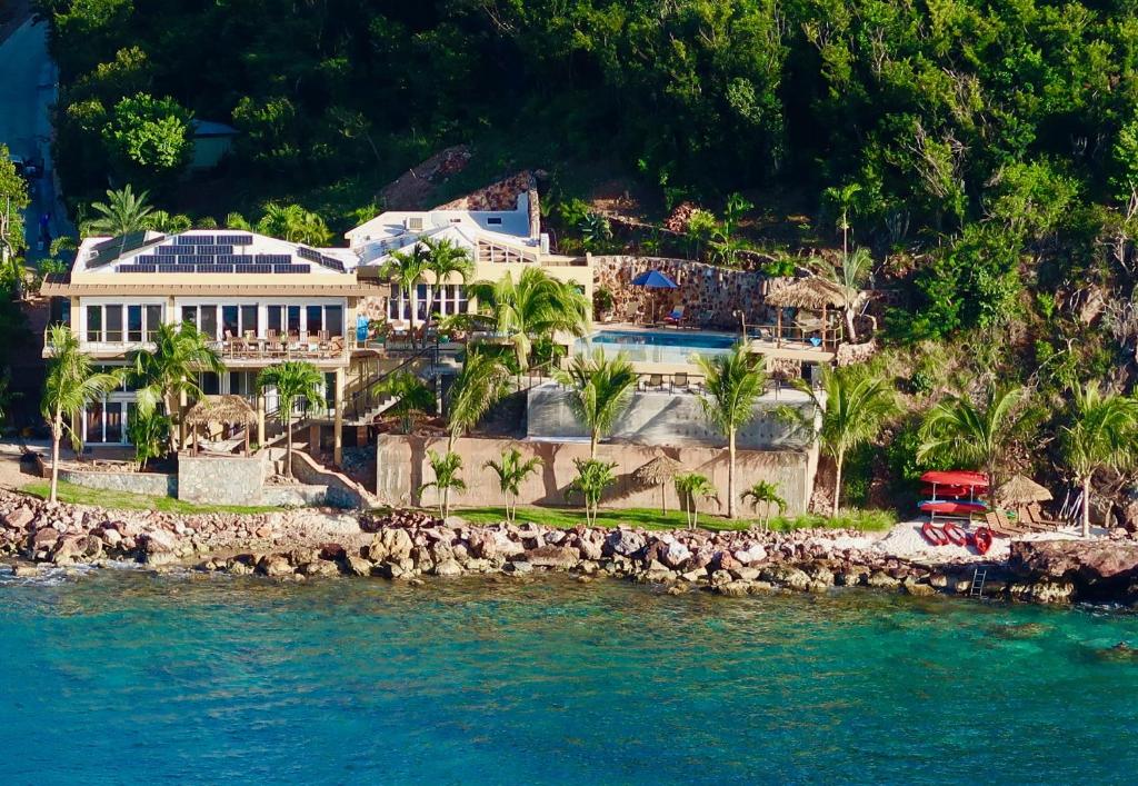 an aerial view of a house on the shore of the water at Lime in de Coconut Villa in Cruz Bay