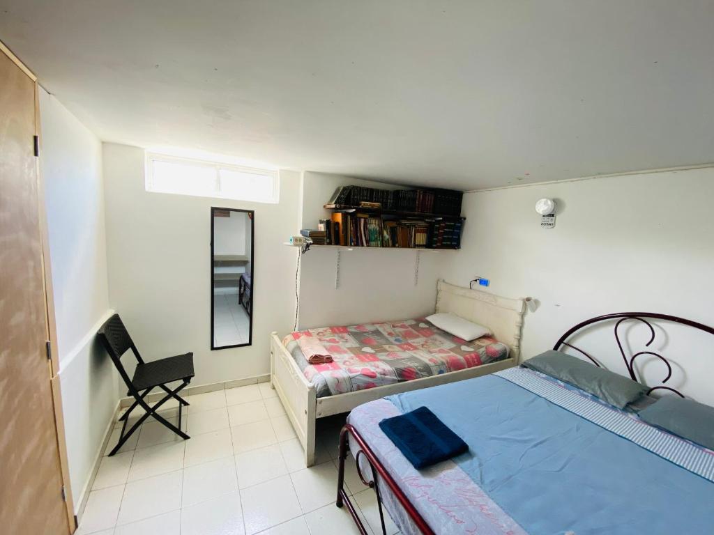 Voodi või voodid majutusasutuse Casa Feliz Hostal toas