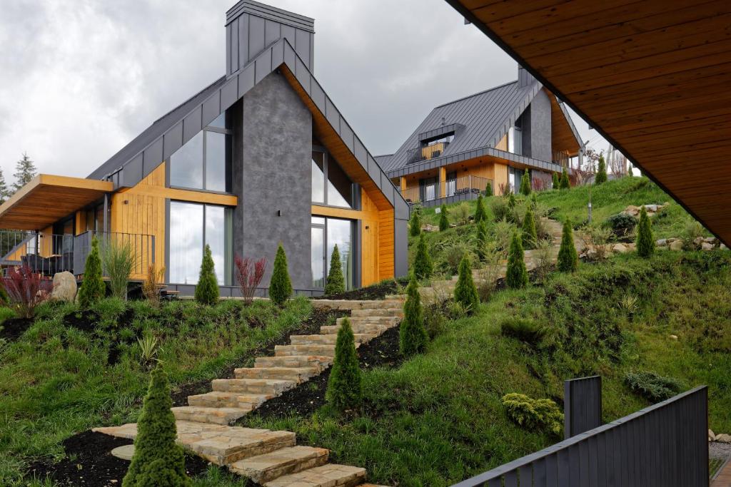 a house on top of a hill with stairs at SKOGUR - Home & Resort in Bukovel