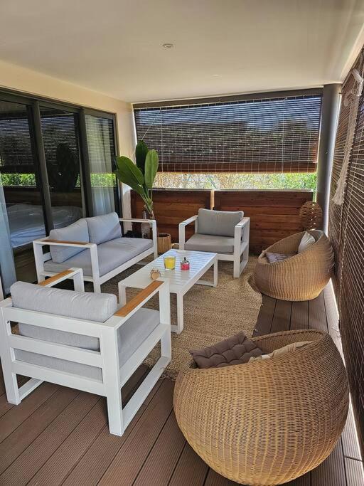 a porch with chairs and a table and chairs at Private Secured 4 Bedroom Villa in Grand-Baie
