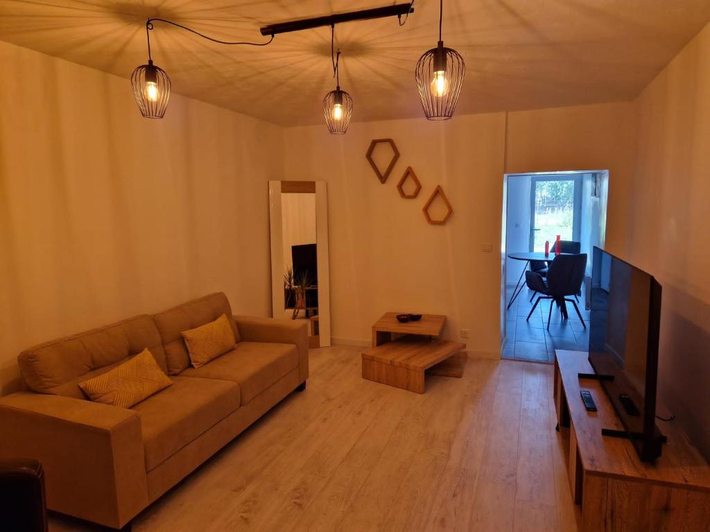 uma sala de estar com um sofá e uma mesa em Entre lac et montagne em Cluses