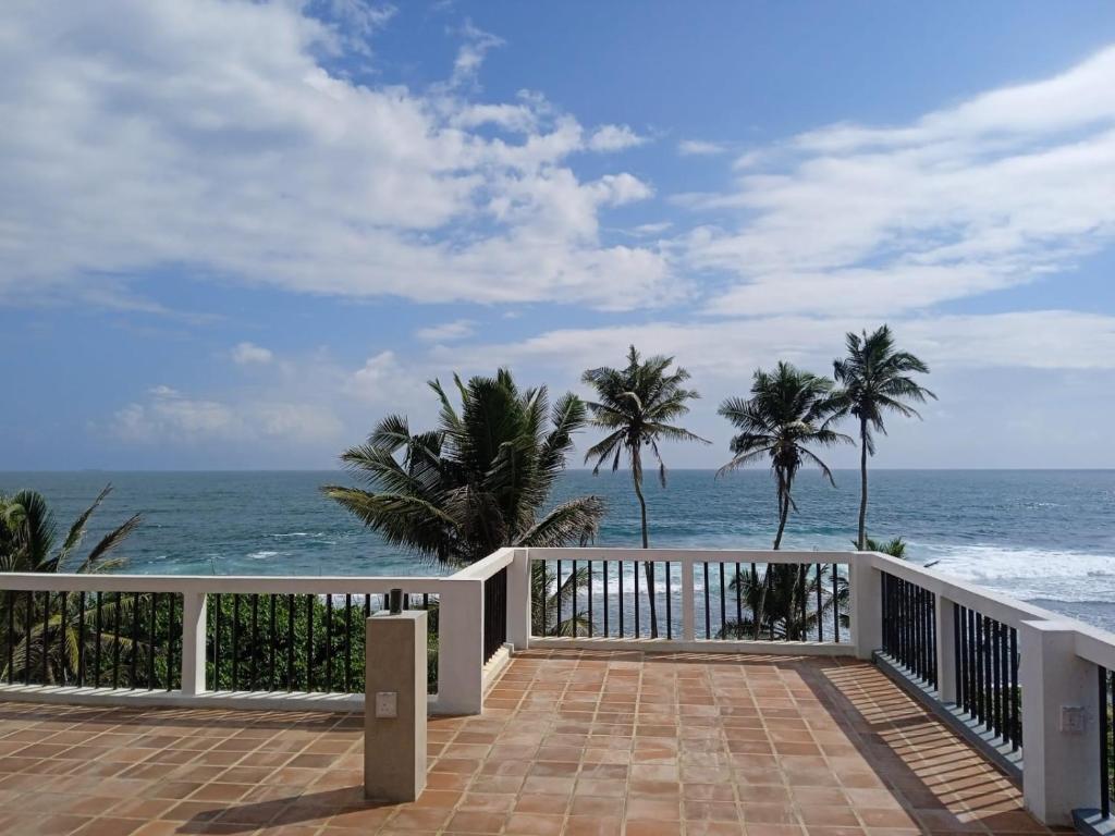 a balcony with a view of the ocean at PearlDrop Waves Mirissa in Mirissa