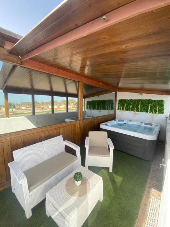 a living room with a tub on a boat at Beach Villa private heated pool in Caleta De Fuste