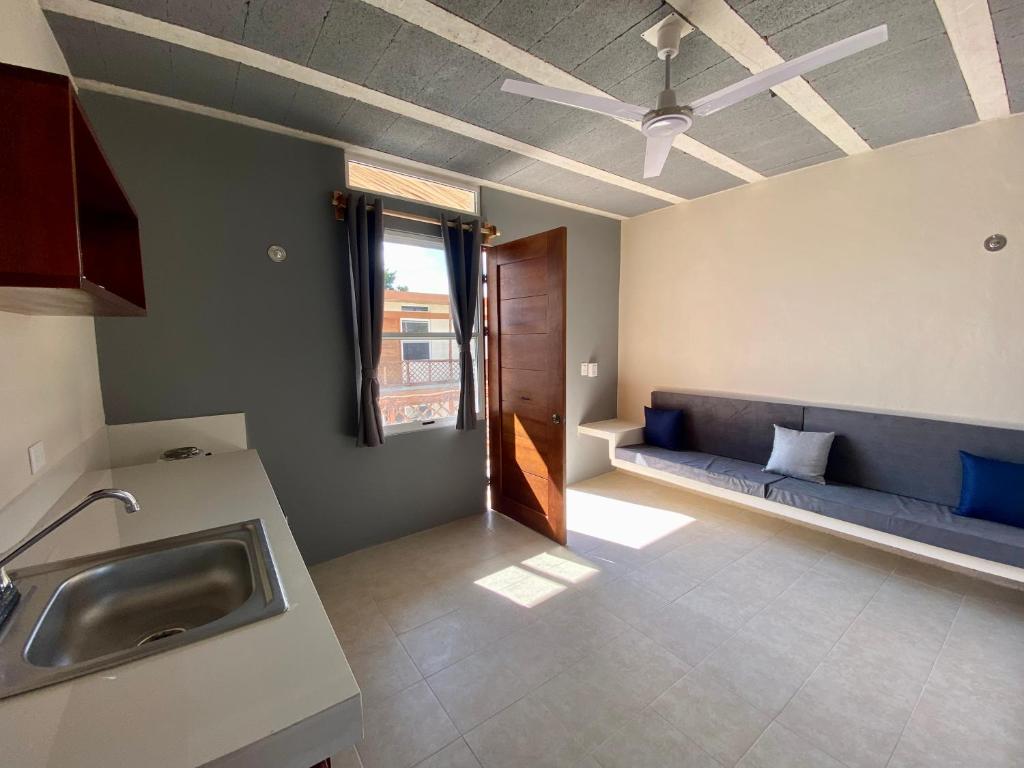 a kitchen with a sink and a ceiling fan at Casa Cielito Lindo Cozumel in Cozumel