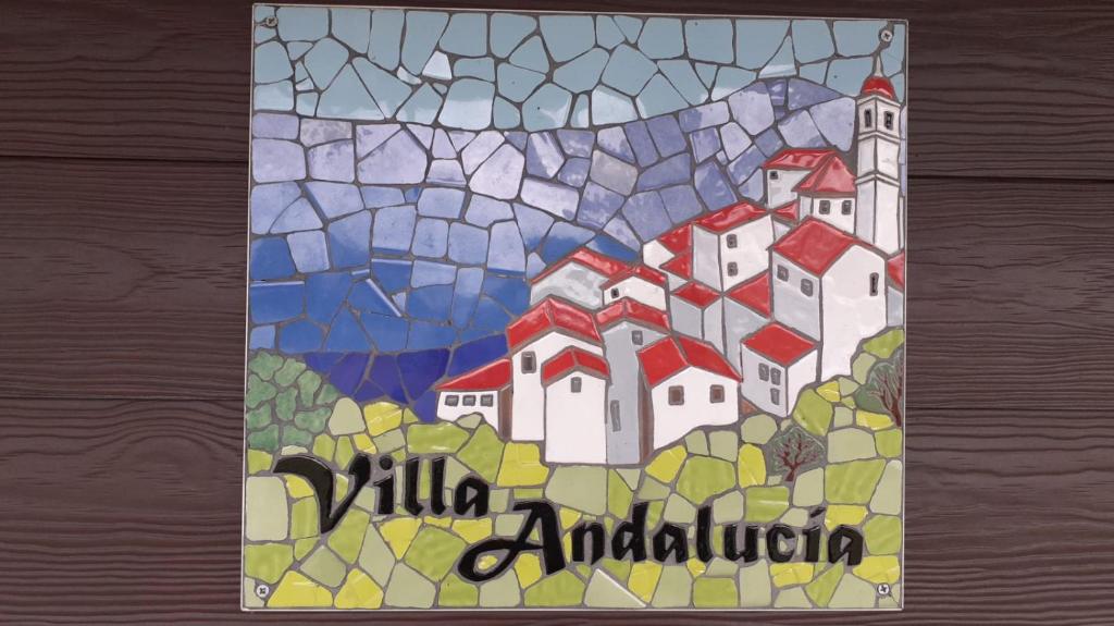 a stained glass picture of a village on a hill at Villa Andalucia in Chonchi