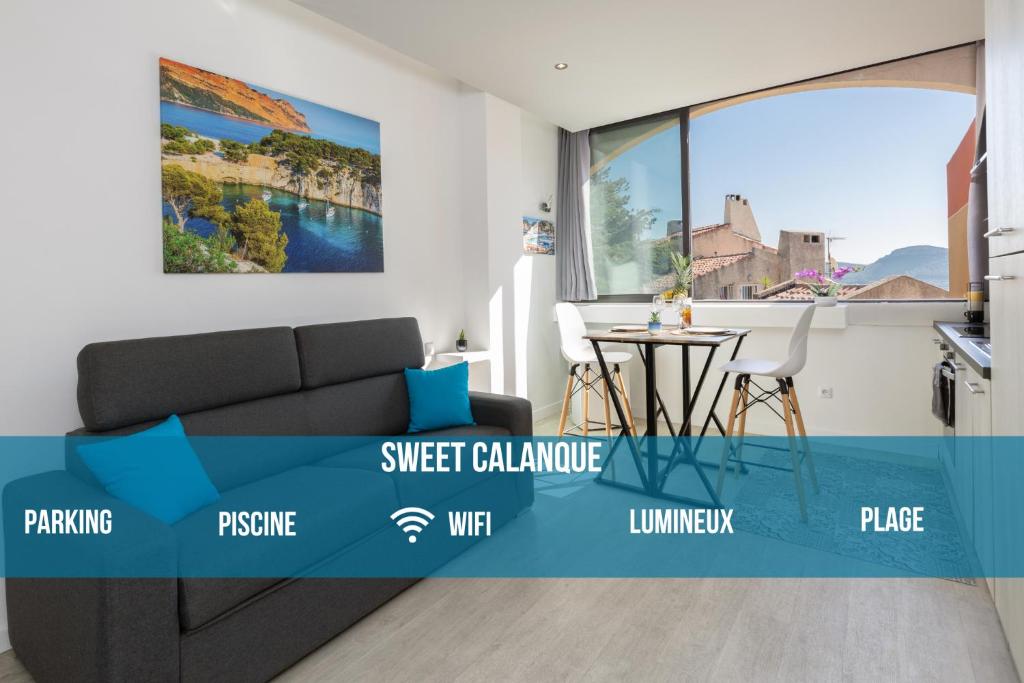 a living room with a couch and a large window at Sweet Calanque - Host Provence in Cassis