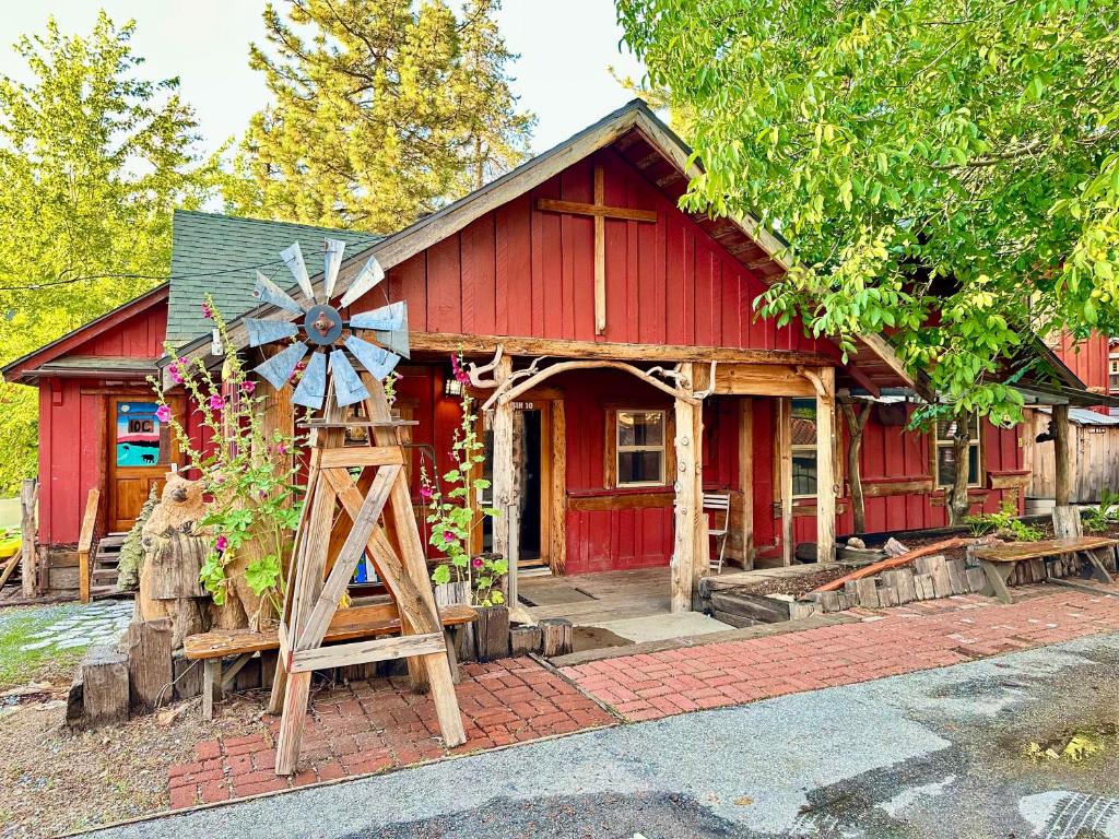 a red house with a windmill in front of it at Boulder Bay Cottages in Big Bear Lake