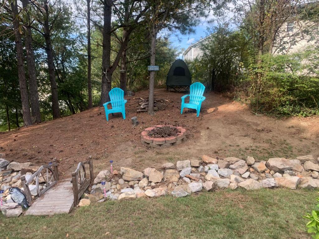 two blue chairs and a fire pit in a yard at Happy Place in Conley