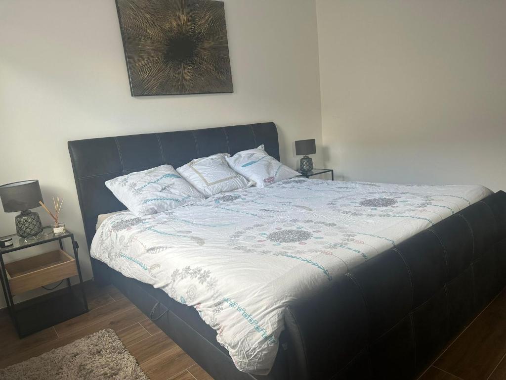 a bed with a blue headboard in a bedroom at APPT RUE DE STRASBOURG in Luxembourg