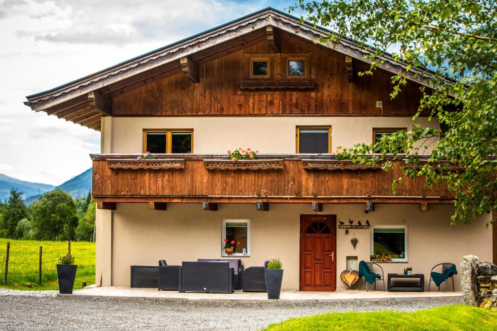 a house with a wooden roof at Mountain Lodge in Neukirchen am Großvenediger