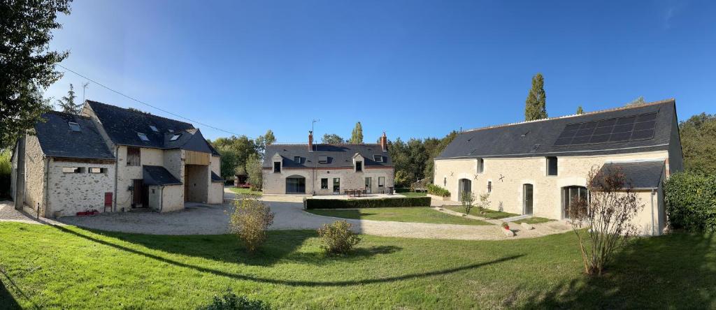 a group of buildings with a yard and a house at Les gîtes de La Pellerie - 2 piscines &amp; spa Jacuzzi - Touraine - 3 gîtes - familial, calme, campagne in Saint-Branchs