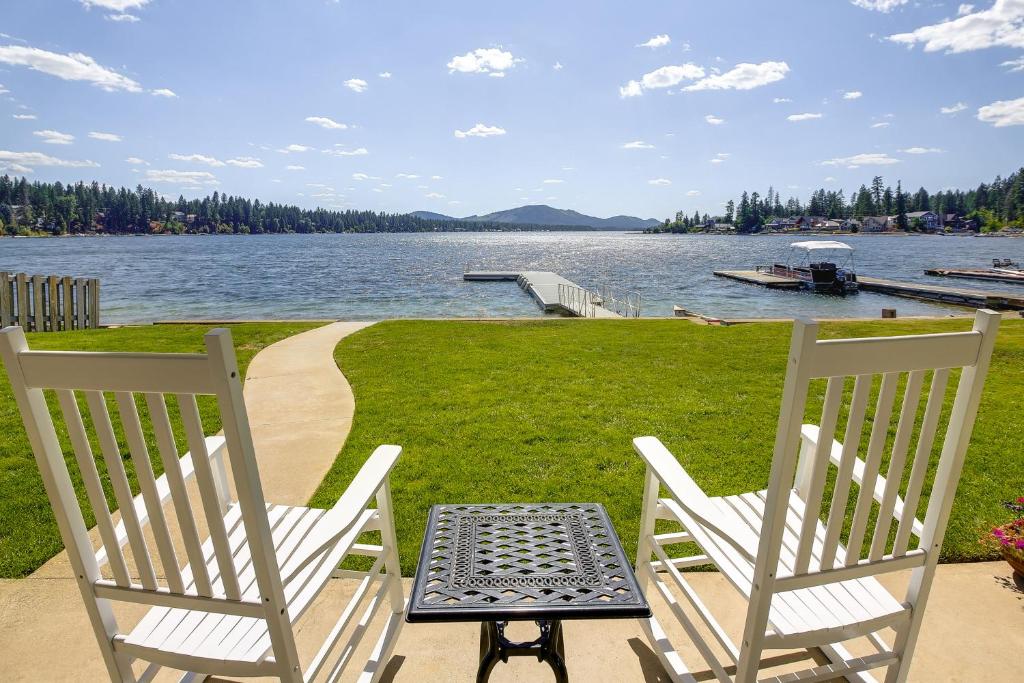two chairs and a table sitting next to a lake at Waterfront Newport Home with Private Boat Dock! in Newport