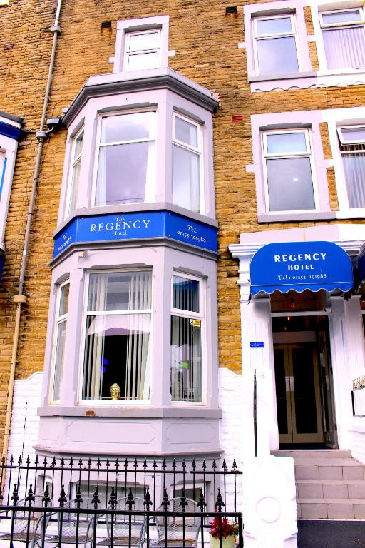 a building with blue signs on the front of it at The Regency Hotel in Blackpool