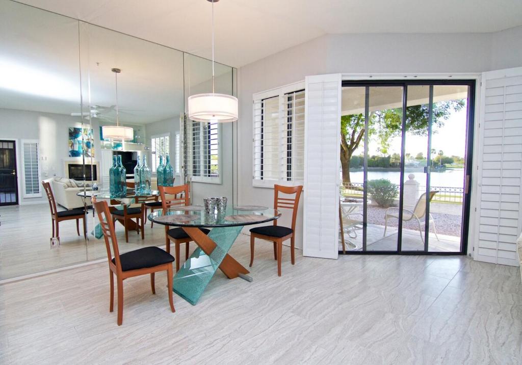 a dining room and kitchen with a glass table and chairs at Waterfront Views, Office, Main Floor, Walkable in Scottsdale