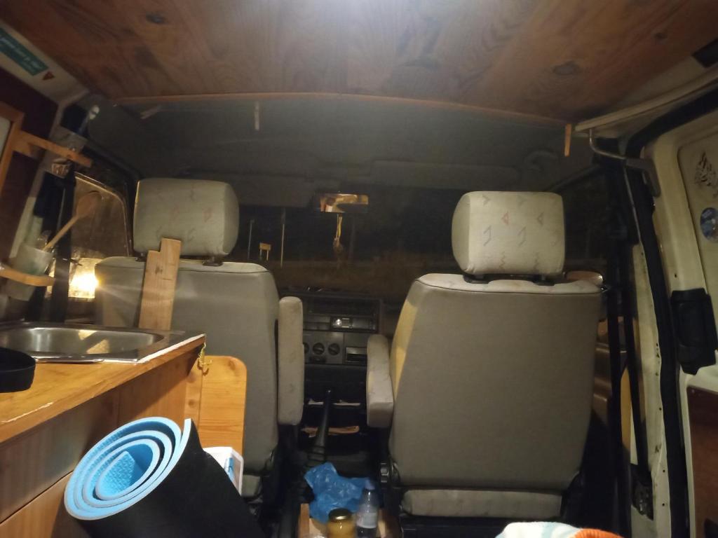 an rv with two seats and a sink in it at Van à louer au pied des pistes in Bourg-Saint-Maurice