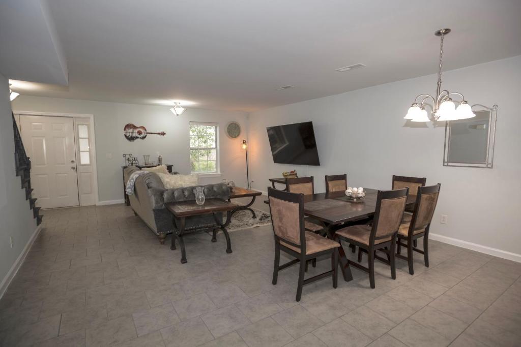 a dining room and living room with a table and chairs at Elegant 3 bedroom apt with free parking and balcony in Nashville