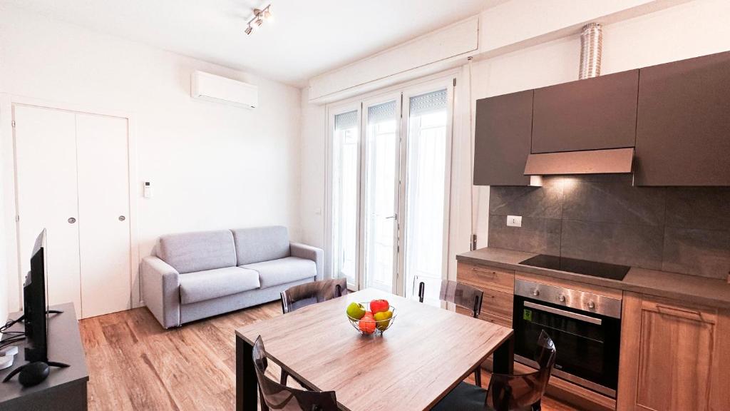 a kitchen with a table with a bowl of fruit on it at Ghiberti Boutique Apartment in Florence