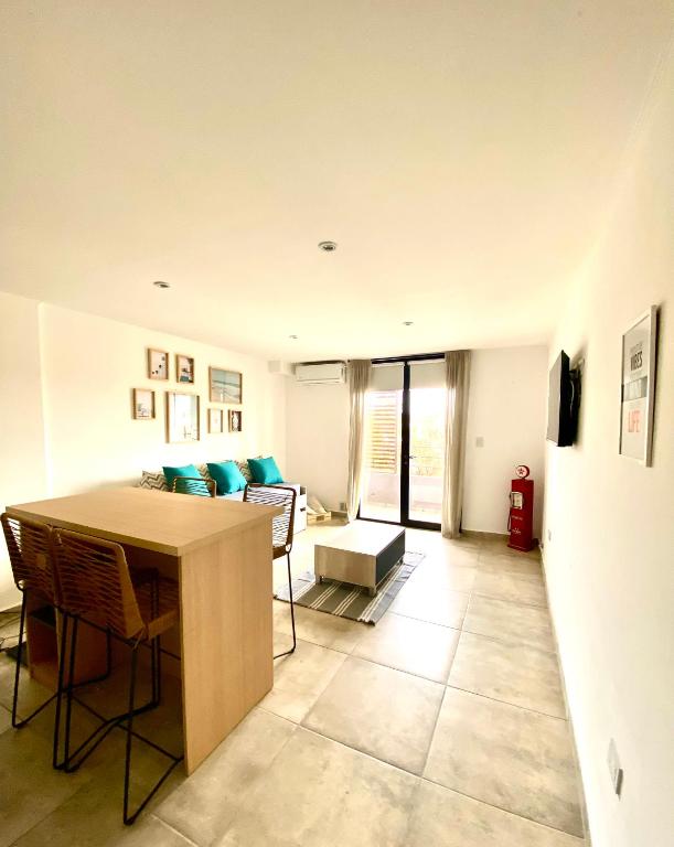 a living room with a table and a couch at FINCA NOVA Apartment 4 in Balcarce
