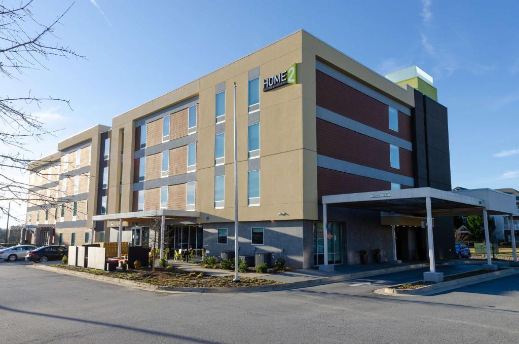 a hotel building with a sign on the front of it at Home2 Suites By Hilton Atlanta Camp Creek Parkway, Ga in Atlanta