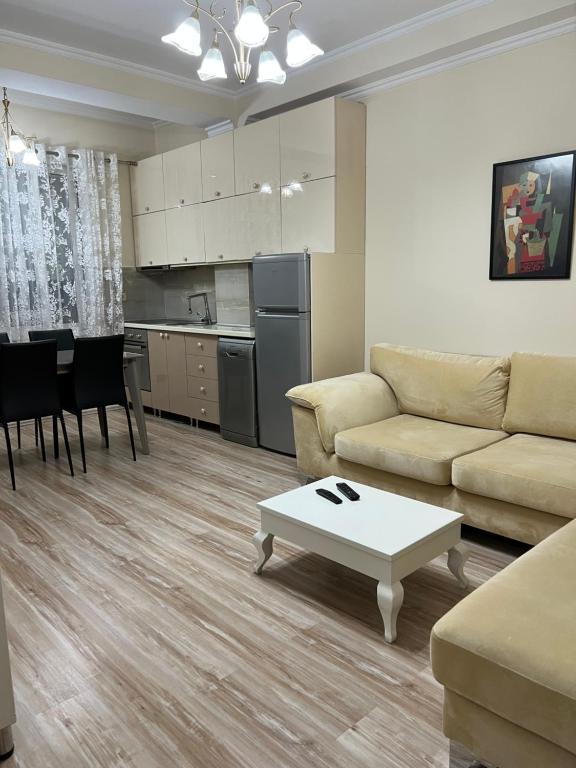 a living room with a couch and a table at Ergi’s Host Apartment in Tirana