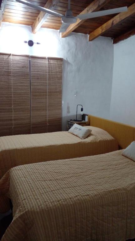 a bedroom with two beds and a window in it at Bella vista a las sierras in Merlo
