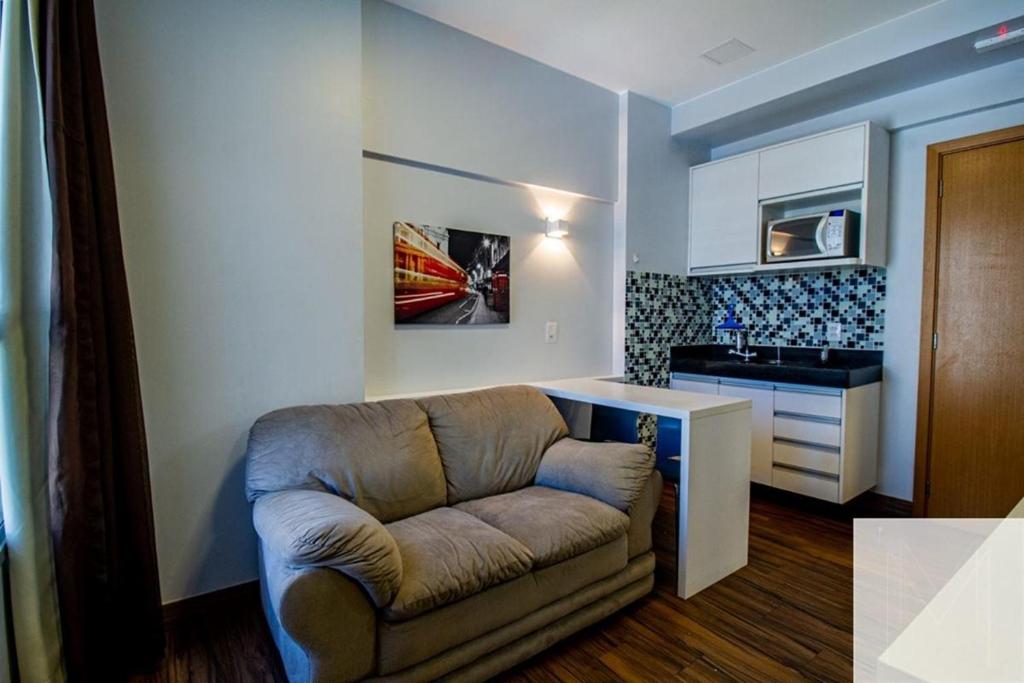 a living room with a couch and a kitchen at S4 Hotel - Studio particular - Apt 620 - Águas Claras in Brasilia