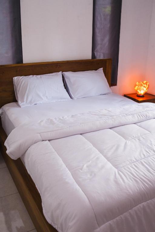 Postel nebo postele na pokoji v ubytování Timbul Homestay
