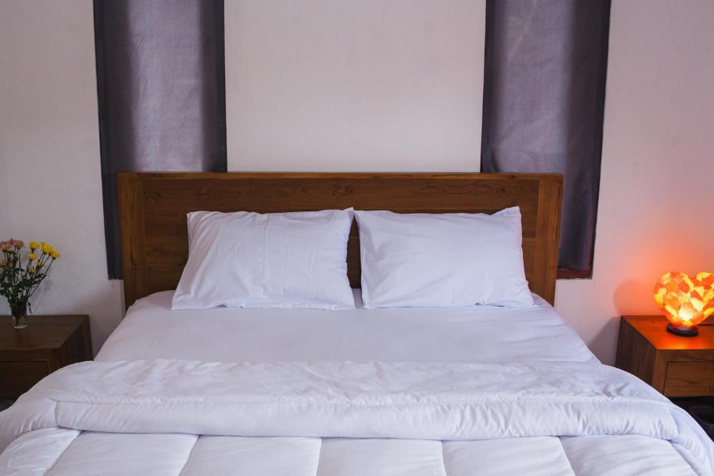 Postel nebo postele na pokoji v ubytování Timbul Homestay