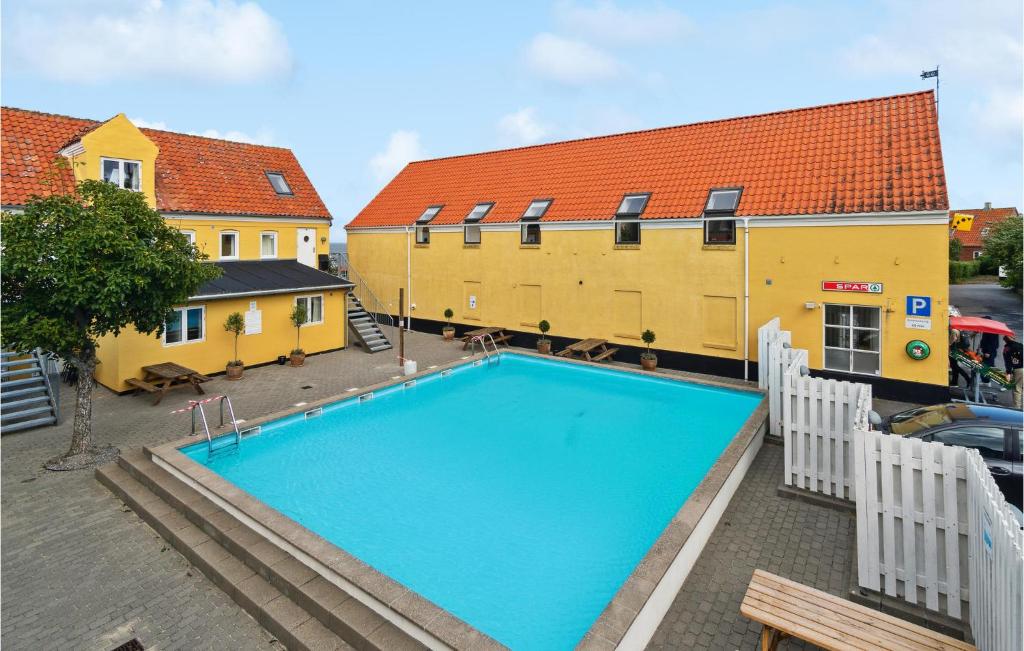 an overhead view of a swimming pool in front of a building at Stunning Apartment In Gudhjem With Wifi in Gudhjem