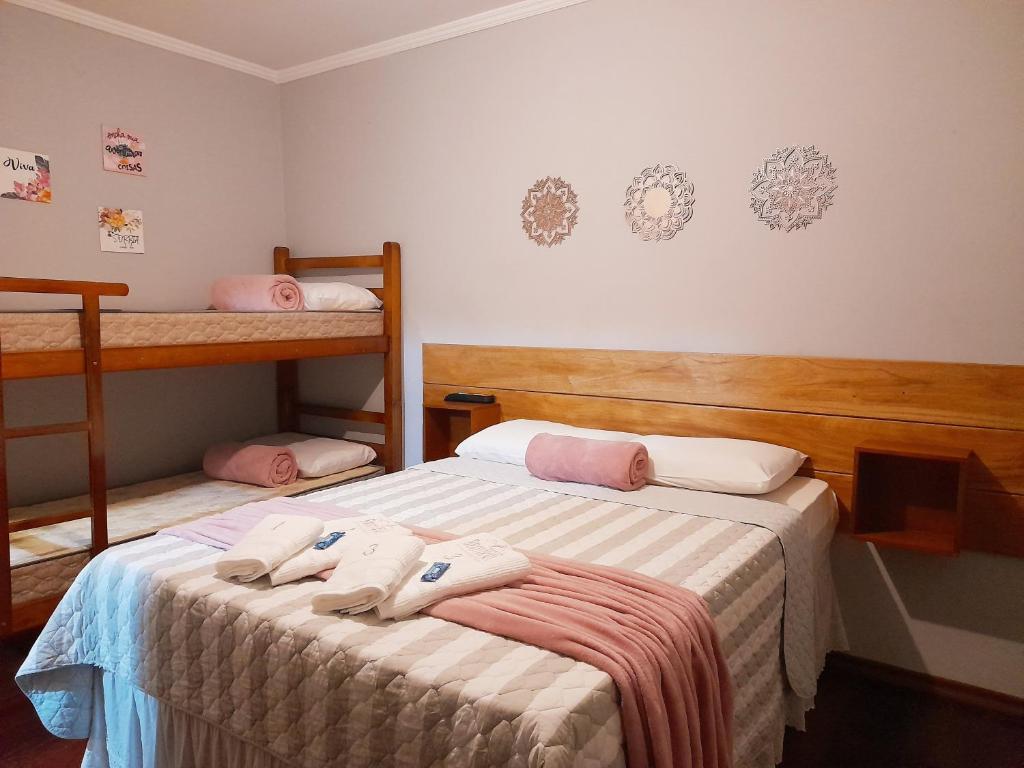 two beds in a room with two bunk beds at Pousada Bem te vi in Bragança Paulista
