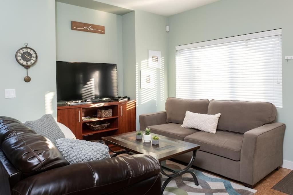 a living room with a couch and a coffee table at Sun & Sails Villa by the Beach in Penticton