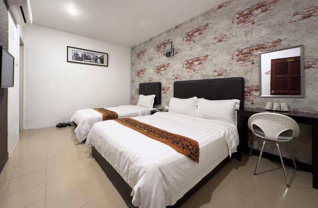 a hotel room with two beds and a mirror at Inn Residence 18 in George Town
