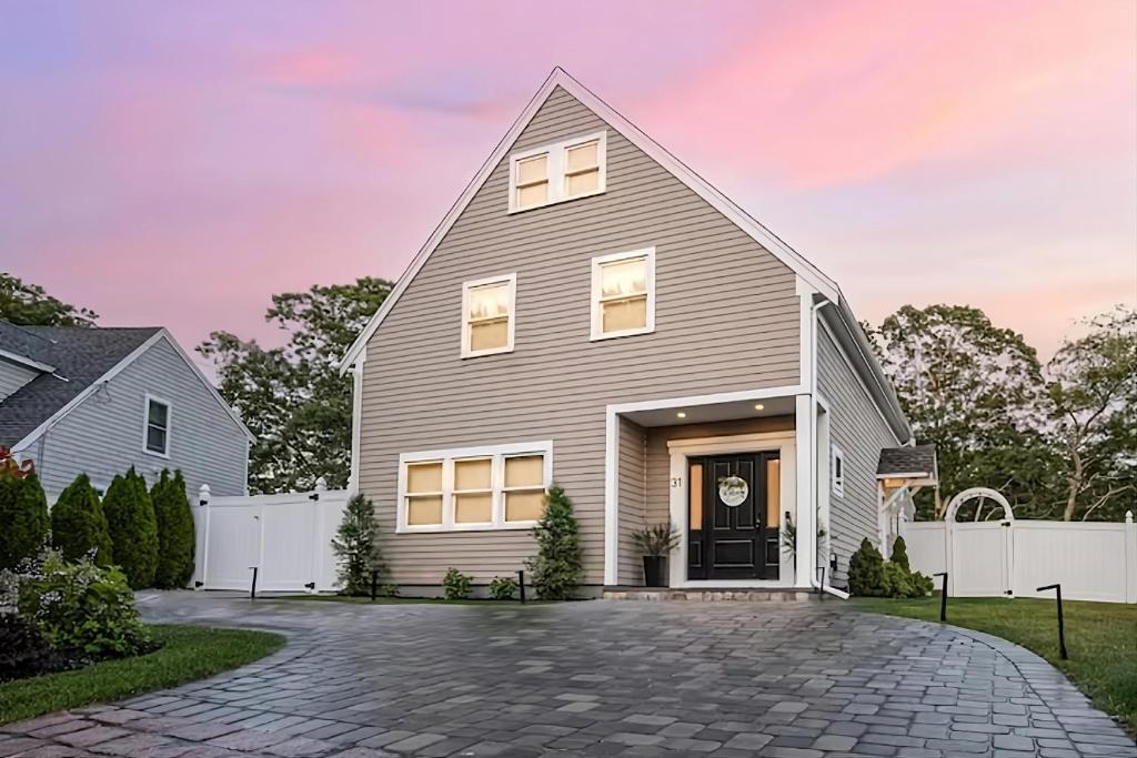 een grijs huis met een gambrel dak bij Renovated & Sophisticated Home Near Beach & Shops! in Barnstable