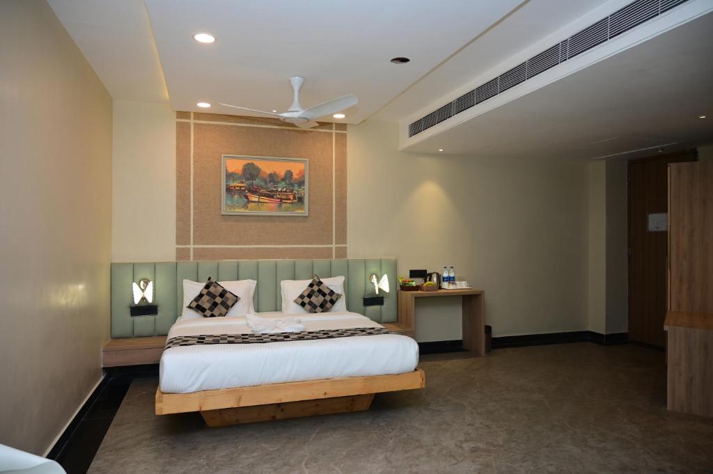 a bedroom with a bed and a ceiling at Pipul Ocean View Resort in Puri