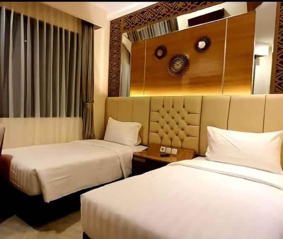 Postel nebo postele na pokoji v ubytování Hotel Daily Inn Bandung