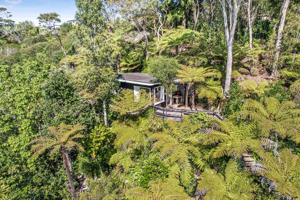 an aerial view of a house in the forest at The Treehouse - Raglan Holiday Studio in Raglan