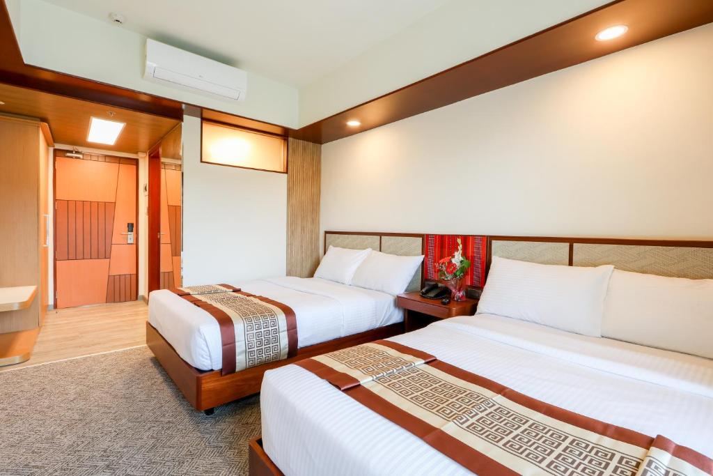 Postel nebo postele na pokoji v ubytování Sotogrande Hotel Baguio