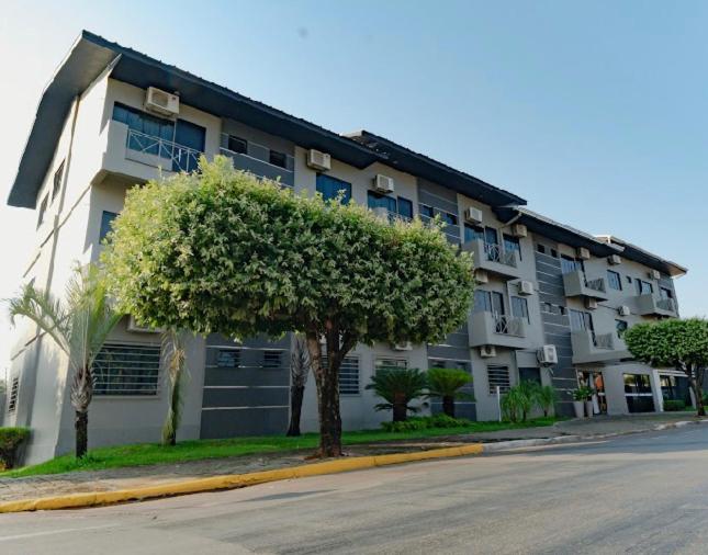 un grand immeuble situé sur le côté d'une rue dans l'établissement FLORENÇA PALACE HOTEL, à Lucas do Rio Verde