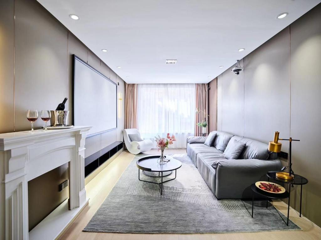 a living room with a couch and a fireplace at Datong Elite Apartment, Peoples Square, CBD in Shanghai