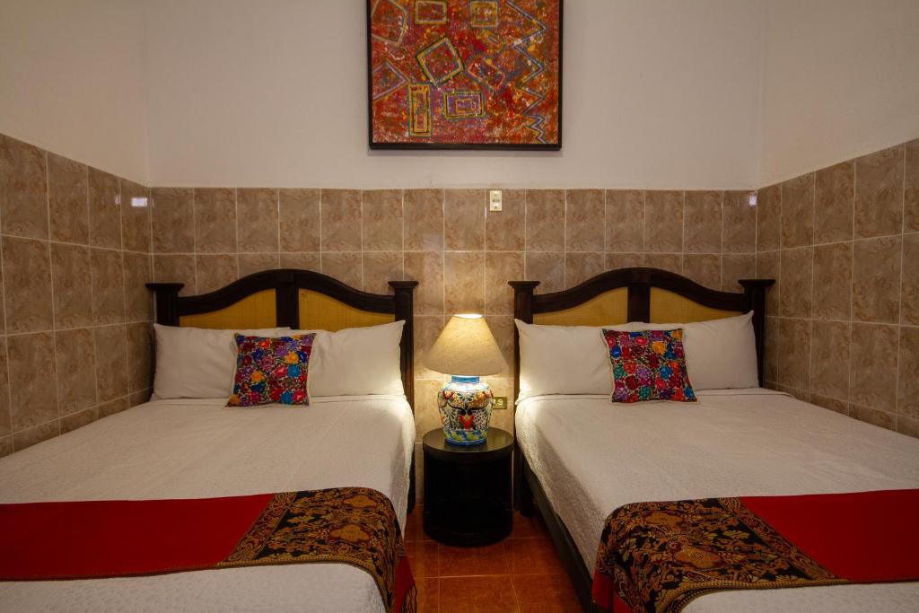 Postel nebo postele na pokoji v ubytování Hotel del Sol
