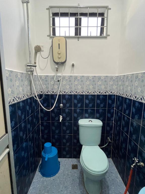 y baño con aseo y ducha. en AR HOMESTAY KUALA TERENGGANU en Kuala Terengganu